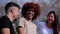 Portrait of a group of teenage students smiling and bonding at university campus. Three multiracial friends talking and