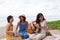 Portrait group of young asian woman playing guitar in sea beach