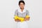 Portrait of grumpy attractve maid in uniform and yellow rubber g