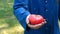 A portrait guy, a farmer in a straw hat, a working robe picks up a tomato in the garden in the field makes a bite and eats, afte