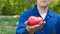 A portrait guy, a farmer in a straw hat, a working robe picks up a tomato in the garden in the field makes a bite and eats, afte