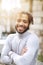 Portrait of half african boy wearing grey turtleneck sweater and having curly brown hair.