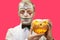 Portrait of halloween man with pumpkin. Man with halloween makeup. Halloween party concept.