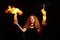 Portrait of a Halloween witch imposes a flame spell. Beautiful redhead woman doing witchcraft holds fire in her hands