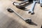 A portrait of  a hammer, a box end and an open end wrench lying on a wooden table. The tools are being used to perform a