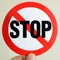 Portrait of Hand Holding Circular Stop Sign Sticker