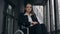 Portrait of handicapped beautiful woman ceo executive in suit sitting in wheelchair at top of office building stairs