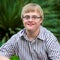 Portrait of handicapped boy wearing glasses.