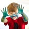 Portrait, hands and a boy painting in studio on white background for creative expression or education at school. Art