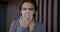 Portrait of handsome Arab man putting on single-use medical mask indoors