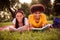 Portrait of handsome beautiful cheerful couple lying on veil reading book inspiration fresh air at forest outdoors