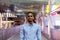 Portrait of handsome black African businessman outdoors in city at night standing at footbridge