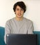 Portrait of handsome boy with computer in quarantine days