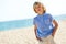 Portrait of handsome boy standing on beach.