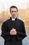 Portrait of handsome catholic priest or pastor with collar