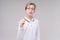 Portrait handsome caucasian boy in glasses who just has an idea points his