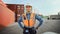 Portrait of a Handsome Caucasian Industrial Engineer in White Hard Hat, Orange High-Visibility Vest