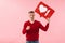 Portrait of handsome caucasian man holding heart like symbol on placard