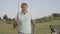 Portrait handsome confident successful middle eastern man with a golf club standing on a golf course in good sunny