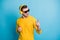 Portrait of handsome guy point fingers dancing listen to nice single look empty space isolated on blue color background