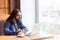 Portrait of handsome intelligence bearded young adult man freelancer in casual style sitting in cafe and searching information for