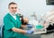 Portrait of handsome male dentist with dental devices in the dental clinic