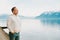 Portrait of handsome man admiring beautiful lake with mountains