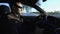 Portrait of handsome man in car in winter