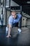 Portrait of a handsome man doing push ups exercise with one hand in fitness gym. dressed in a sports uniform