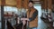 Portrait of handsome man farm at cowshed feedlots. Young man with beard farmer cleaning cowshed barn by pork. Cows