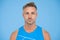 Portrait of handsome man. Grizzled man face blue background. Sportsman in sports vest, man