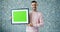 Portrait of handsome man holding chroma key picture frame and showing thumbs-up