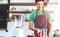 A portrait of handsome man making cold presses fruit juice in a modern kitchen.