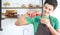 A portrait of handsome man making cold presses fruit juice in a modern kitchen.