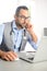 Portrait of handsome man male doctor in medical practice office writing prescription in laptop computer