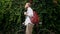 Portrait of handsome man with red backpack walking with bicycle