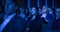 Portrait of a Handsome Man Sitting in a Dark Crowded Auditorium at a Tech Conference. Young Man