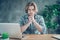 Portrait of handsome man touching his chin looking wearing checkered plaid shirt eyeglasses sitting desk in interior