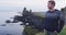 Portrait of handsome Scandinavian man on Iceland wearing sweater. Good looking male model looking at ocean sea. SLOW