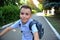 Portrait of handsome school boy with school bag riding bicycle . Child coming back to school