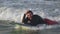 Portrait handsome senior sportsman with beard,happy with riding on the sea waves,lying on surfboard, smiling,looking at