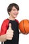Portrait of a handsome smiling basketball player showing thumb u