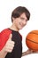 Portrait of a handsome smiling basketball player showing thumb u