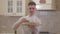Portrait of handsome smiling young man holding wooden plate with pizza close up. Concept of food preparation