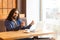 Portrait of handsome young adult man freelancer in casual style sitting in cafe and agrees with his employer for payment through