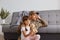 Portrait of handsome young adult soldier man wearing camouflage uniform returning home after army, spending time with daughter,