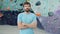 Portrait of handsome young sportsman standing in climbing facility indoors