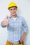 Portrait of a handyman in yellow hard hat gesturing thumbs up