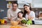 Portrait happiness asian family with father and mother and daughter preparing cooking salad vegetable food together.