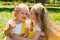 Portrait of happy adorable two sisters children girls outdoor. Cute little kid in summer day